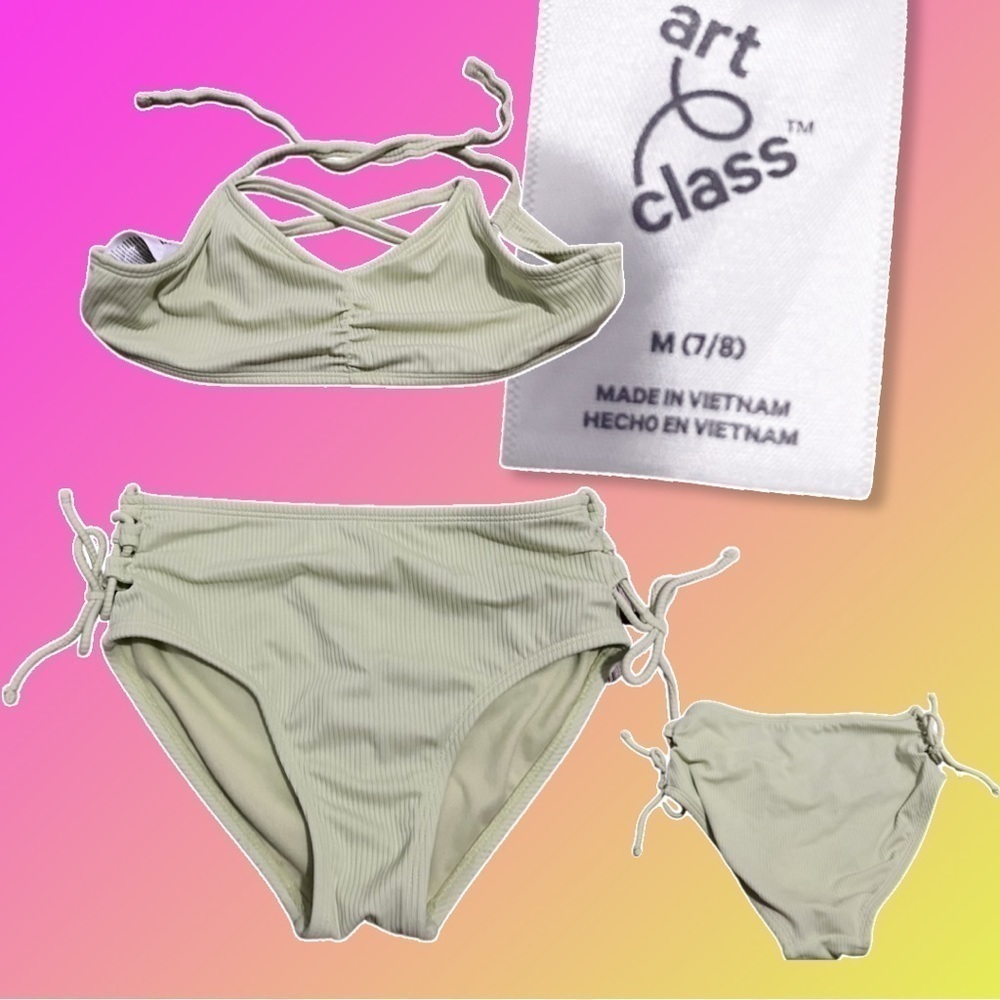 Girls size 7/8 (M) bikini swim suit. Ties at hips and back of ruched top.Ribbed.